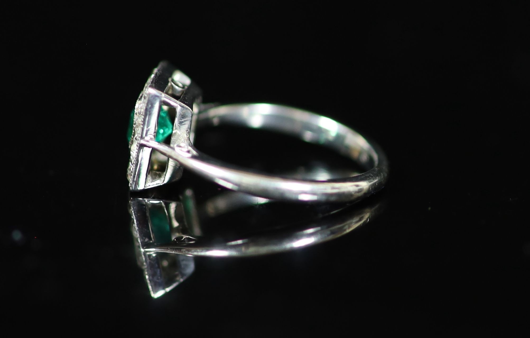 A 1920's platinum, emerald and diamond cluster set tablet ring